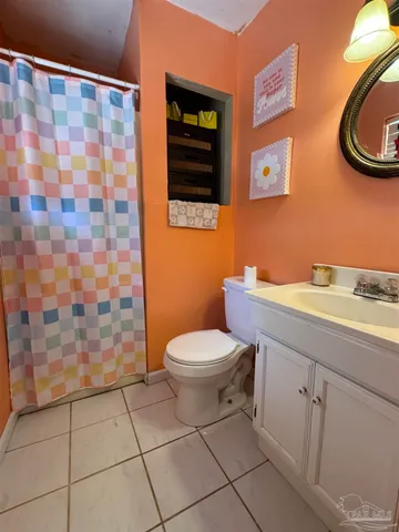 a bathroom with a toilet a sink and a shower
