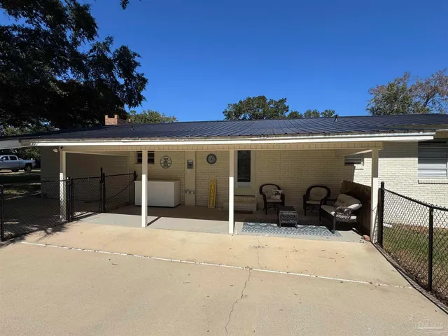 a swimming pool with outdoor seating and yard