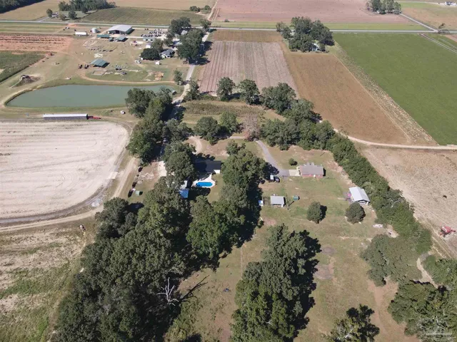 a aerial view of a house with a yard lake and mountain view in back