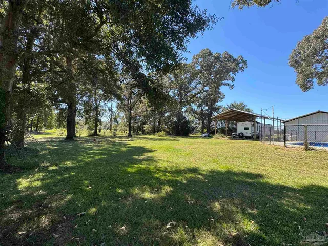 a view of a house with yard and tree s