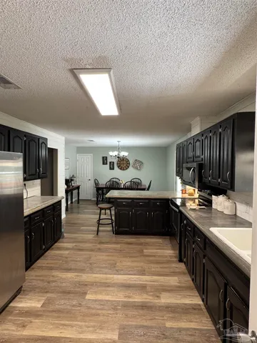 a kitchen with a sink counter top space and stainless steel appliances