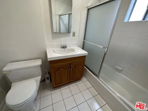a bathroom with a sink a toilet and bathtub