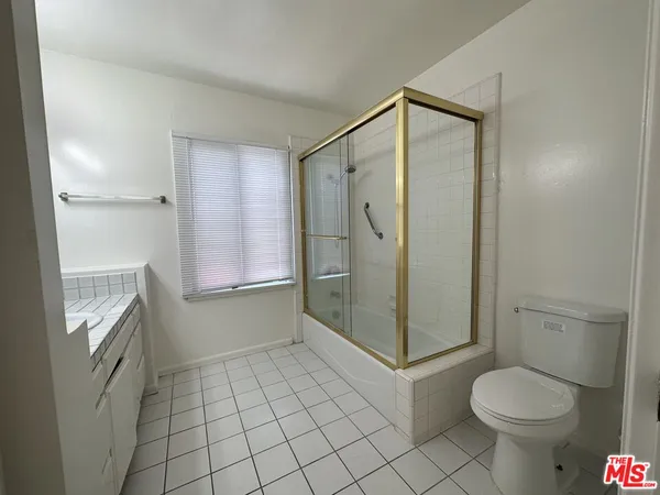 a bathroom with a shower and toilet