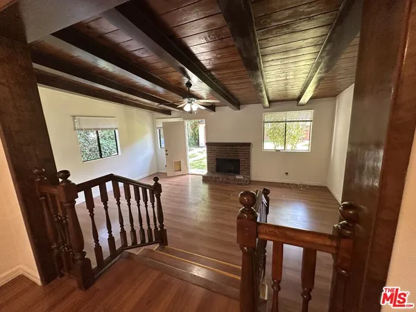 a view of hall way with furniture and a window