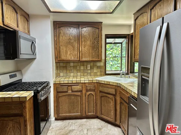 a kitchen with a sink stove and refrigerator