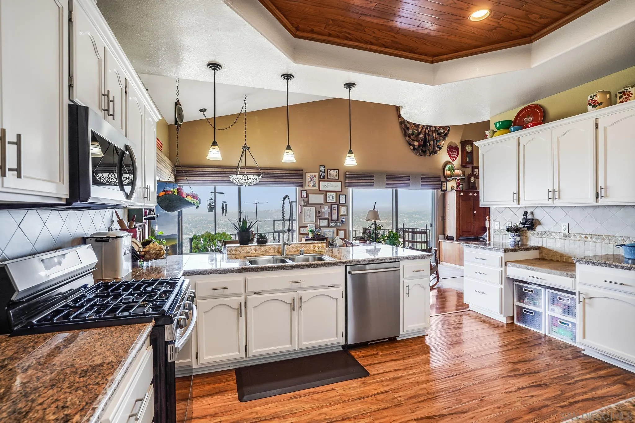 2366 Highview Lane Spring Valley, CA 91977 - Photo 18 of 53 a kitchen with a stove cabinets and wooden floor