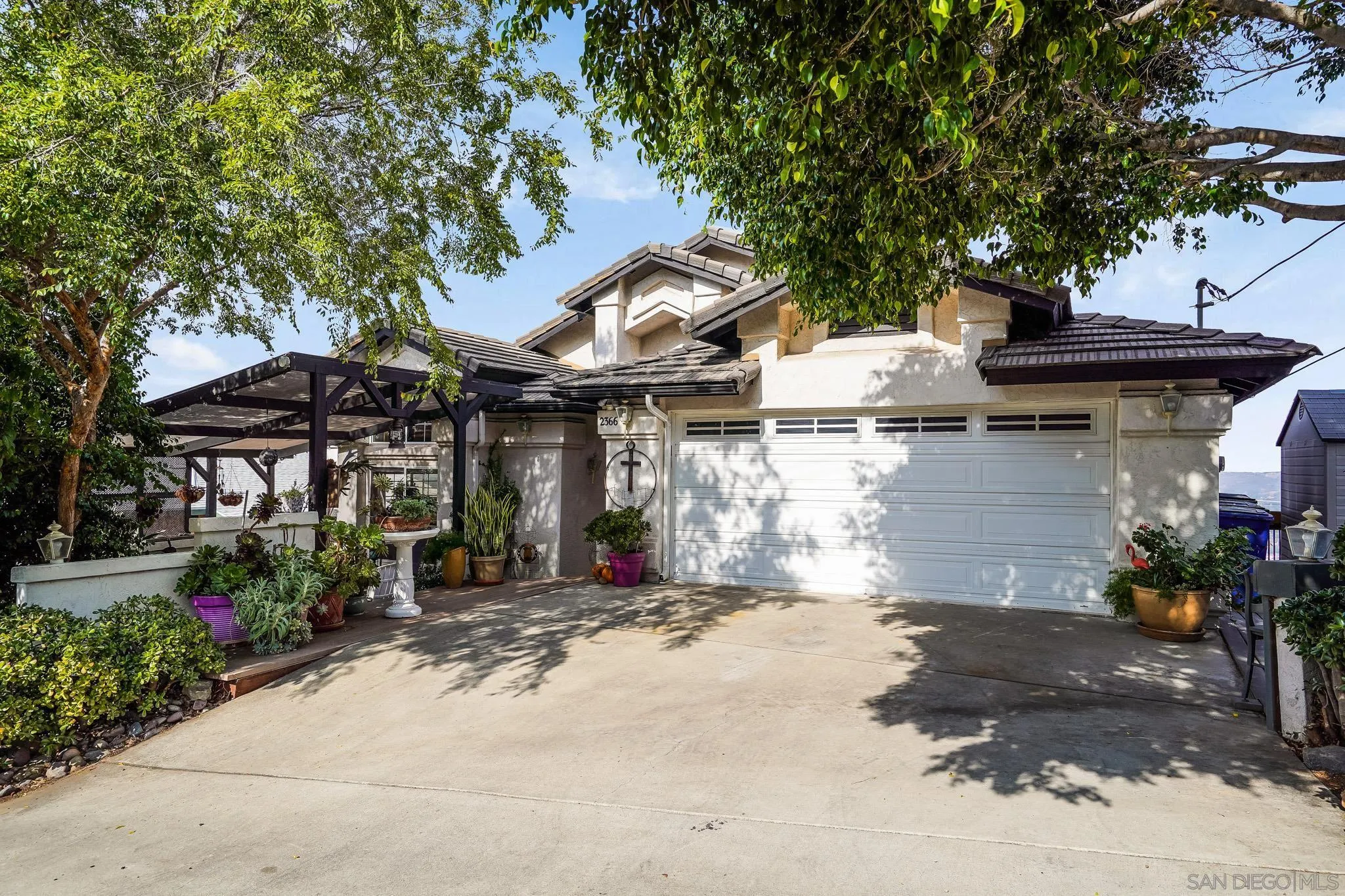 2366 Highview Lane Spring Valley, CA 91977 - Photo 3 of 53 a view of a patio with table and chairs under an umbrella