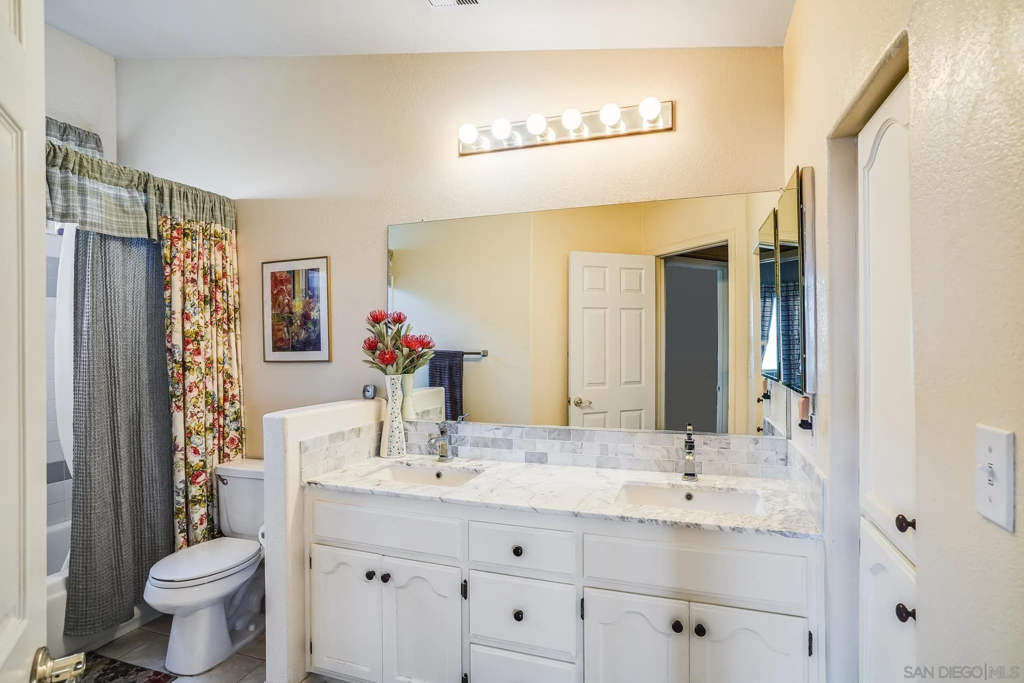2366 Highview Lane Spring Valley, CA 91977 - Photo 35 of 53 a bathroom with a double vanity sink toilet and a mirror