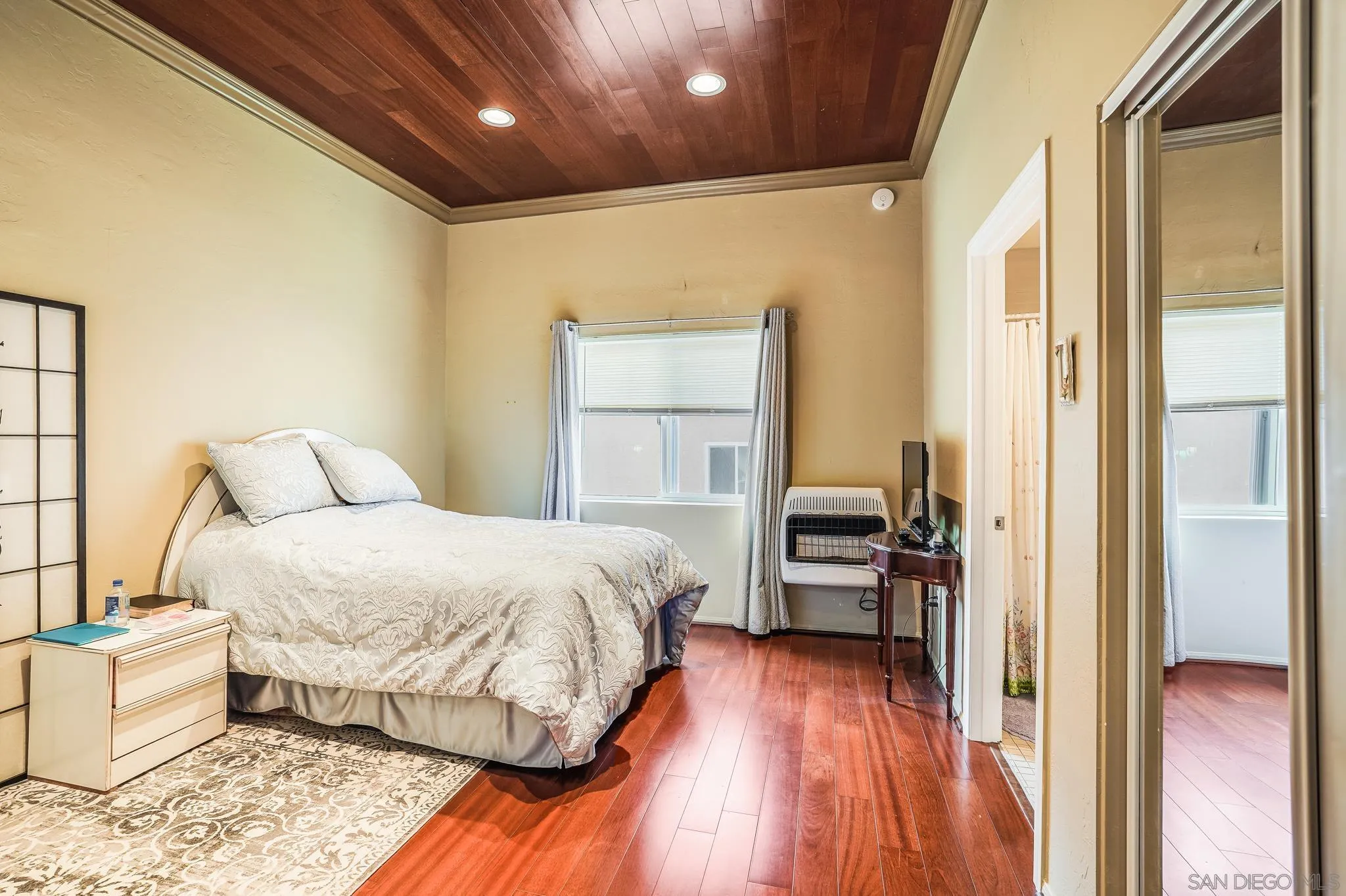 2366 Highview Lane Spring Valley, CA 91977 - Photo 38 of 53 a spacious bedroom with a bed and a wooden floor