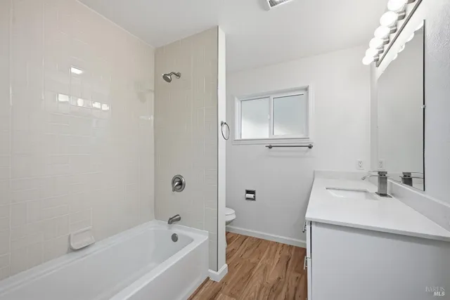 a bathroom with a sink a mirror and a bathtub