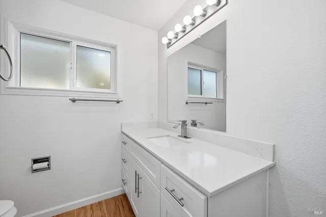 a bathroom with a sink a vanity and a mirror