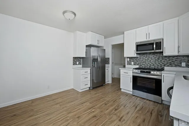 a kitchen with stainless steel appliances a refrigerator stove and microwave