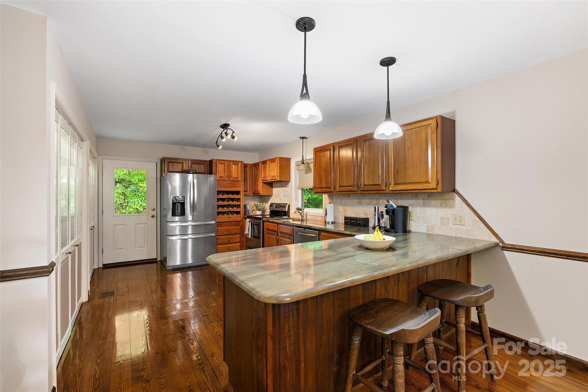 331 Pinnacle Ridge Road Beech Mountain, NC 28604 - Photo 15 of 24 a kitchen with a table chairs sink and wooden floor