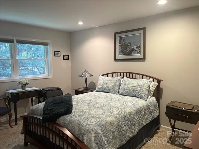 a bedroom with double bed and a window