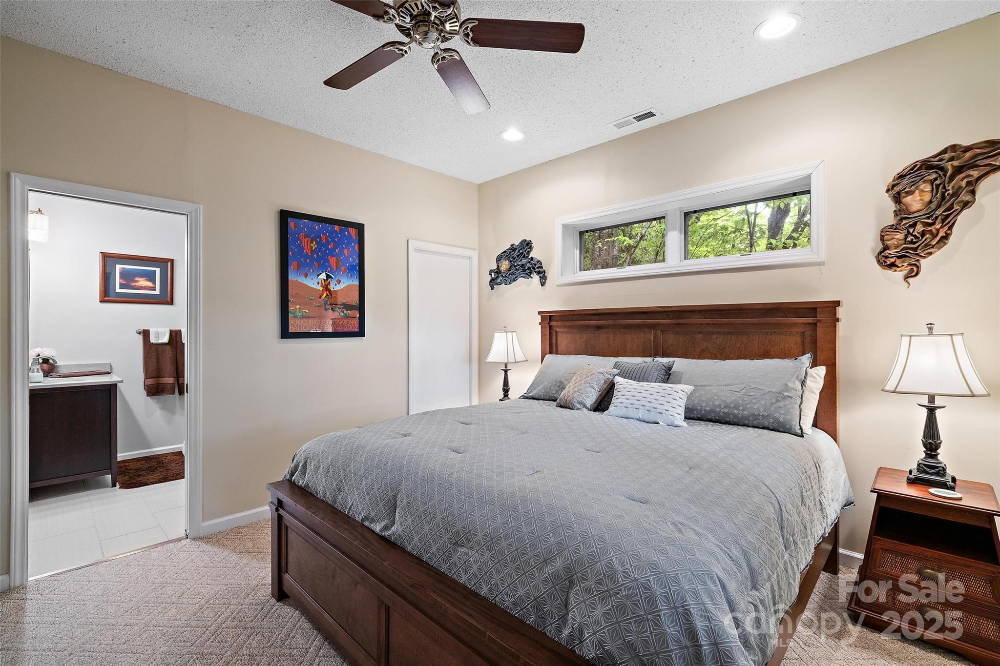 331 Pinnacle Ridge Road Beech Mountain, NC 28604 - Photo 19 of 24 a bedroom with a bed and a chandelier