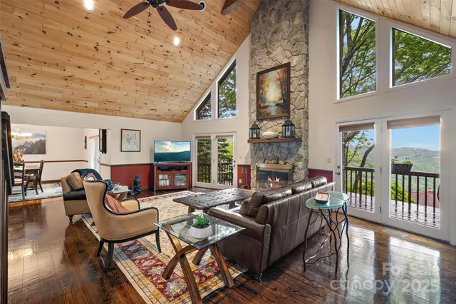a living room with furniture and a floor to ceiling window