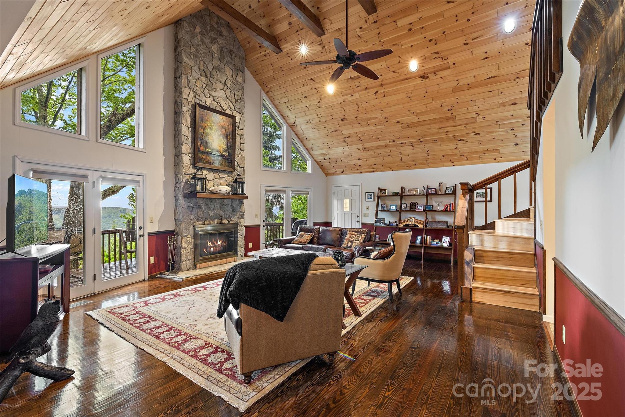 331 Pinnacle Ridge Road Beech Mountain, NC 28604 - Photo 5 of 24 a living room with furniture a rug and a floor to ceiling window