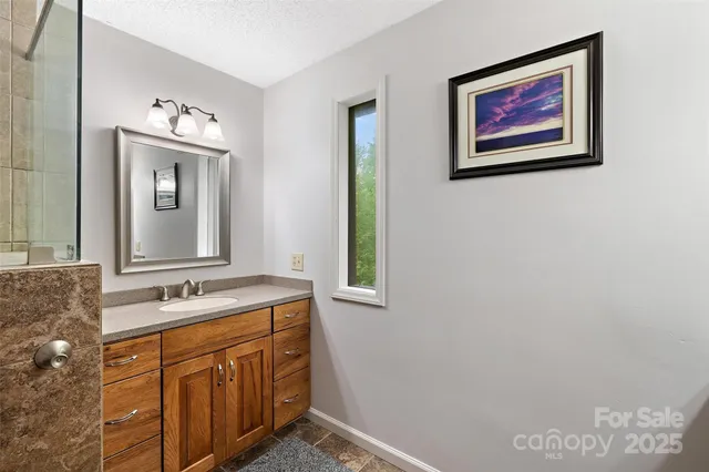 a bathroom with a sink mirror and a window