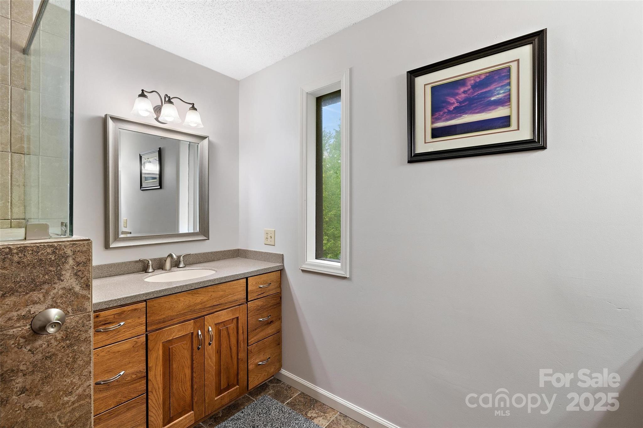 331 Pinnacle Ridge Road Beech Mountain, NC 28604 - Photo 8 of 24 a bathroom with a sink mirror and a window