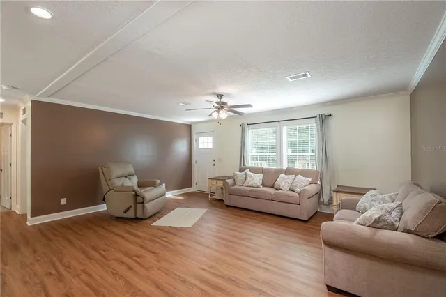 a kitchen with stainless steel appliances granite countertop a refrigerator a stove and a sink