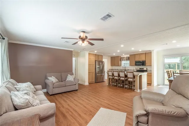 a kitchen with stainless steel appliances granite countertop a stove refrigerator and a microwave