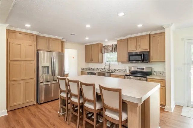 a kitchen with a sink stove top oven and cabinets