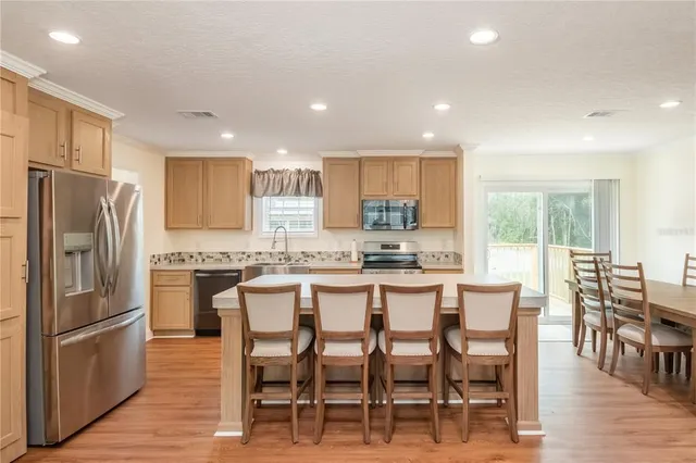 a view of kitchen with cabinets table and chairs