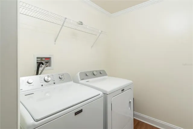 a view of a patio with a table and chairs under an umbrella