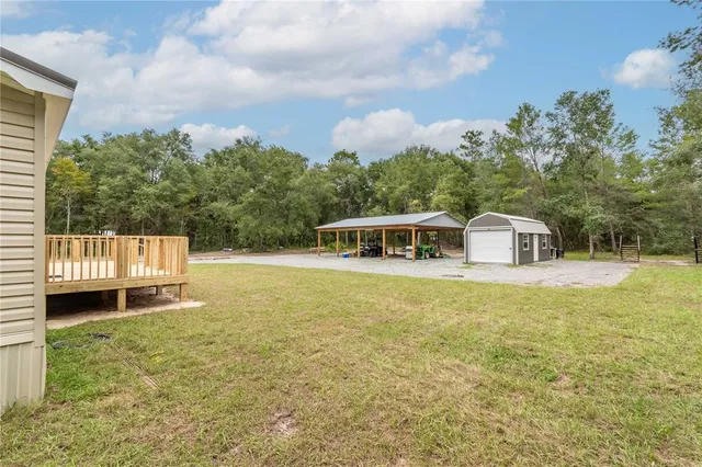 an aerial view of a house with pool table and chairs