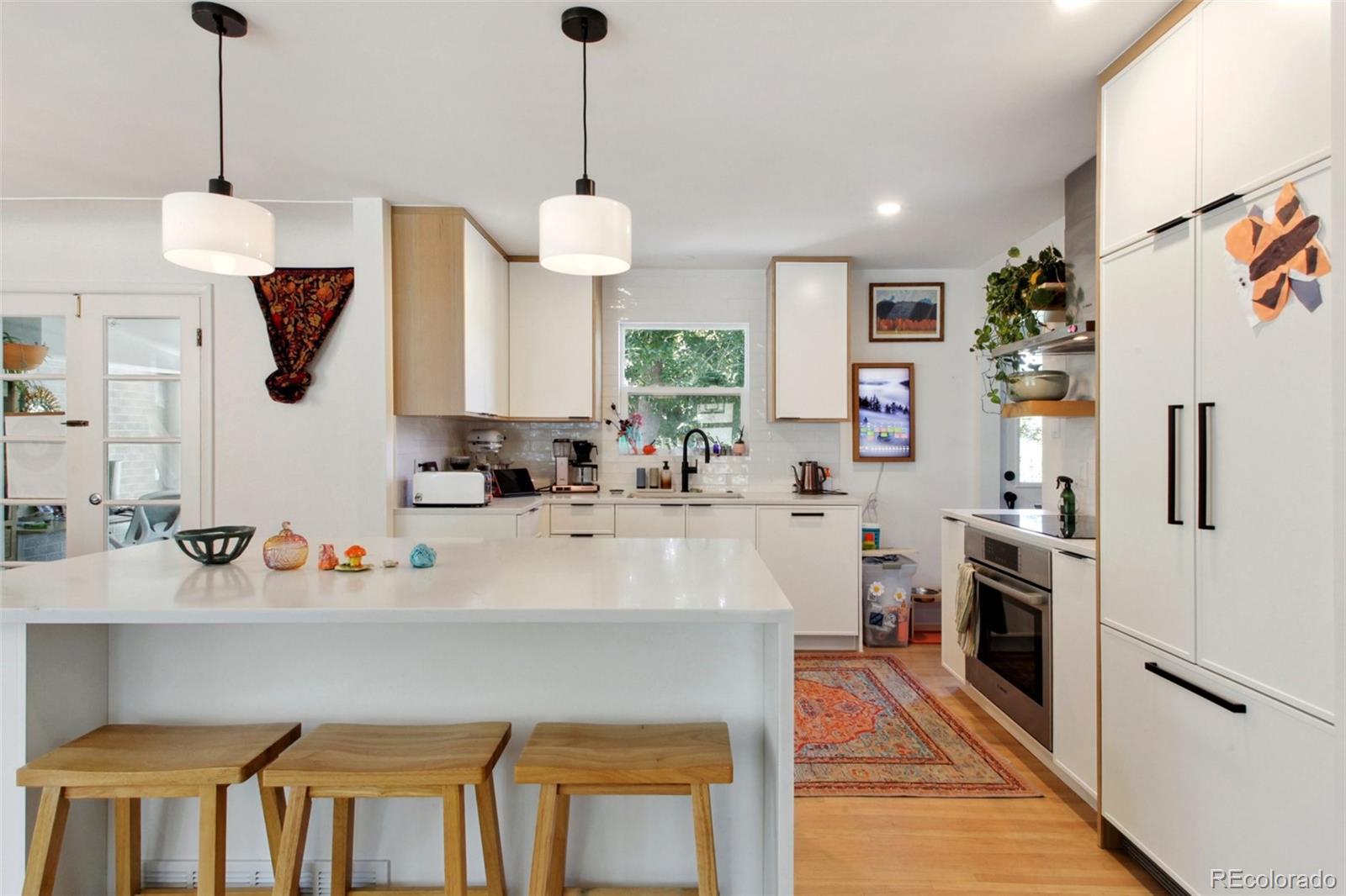 7130 West 30th Avenue Wheat Ridge, CO 80033 - Photo 11 of 37 a kitchen with stainless steel appliances granite countertop a sink a stove and a refrigerator