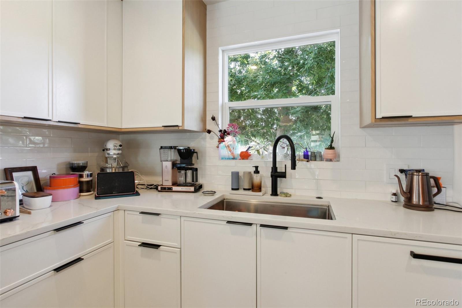 7130 West 30th Avenue Wheat Ridge, CO 80033 - Photo 14 of 37 a kitchen with a sink and cabinets