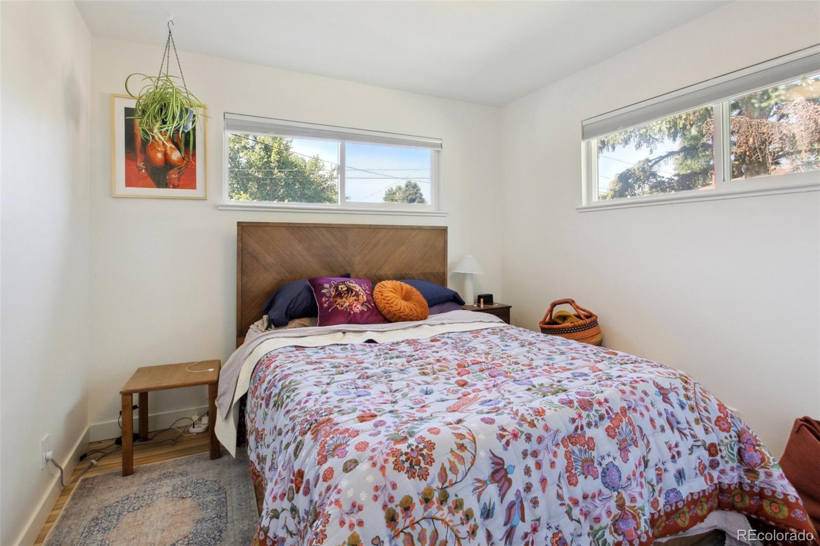 7130 West 30th Avenue Wheat Ridge, CO 80033 - Photo 15 of 37 a bed sitting in a bedroom next to a window
