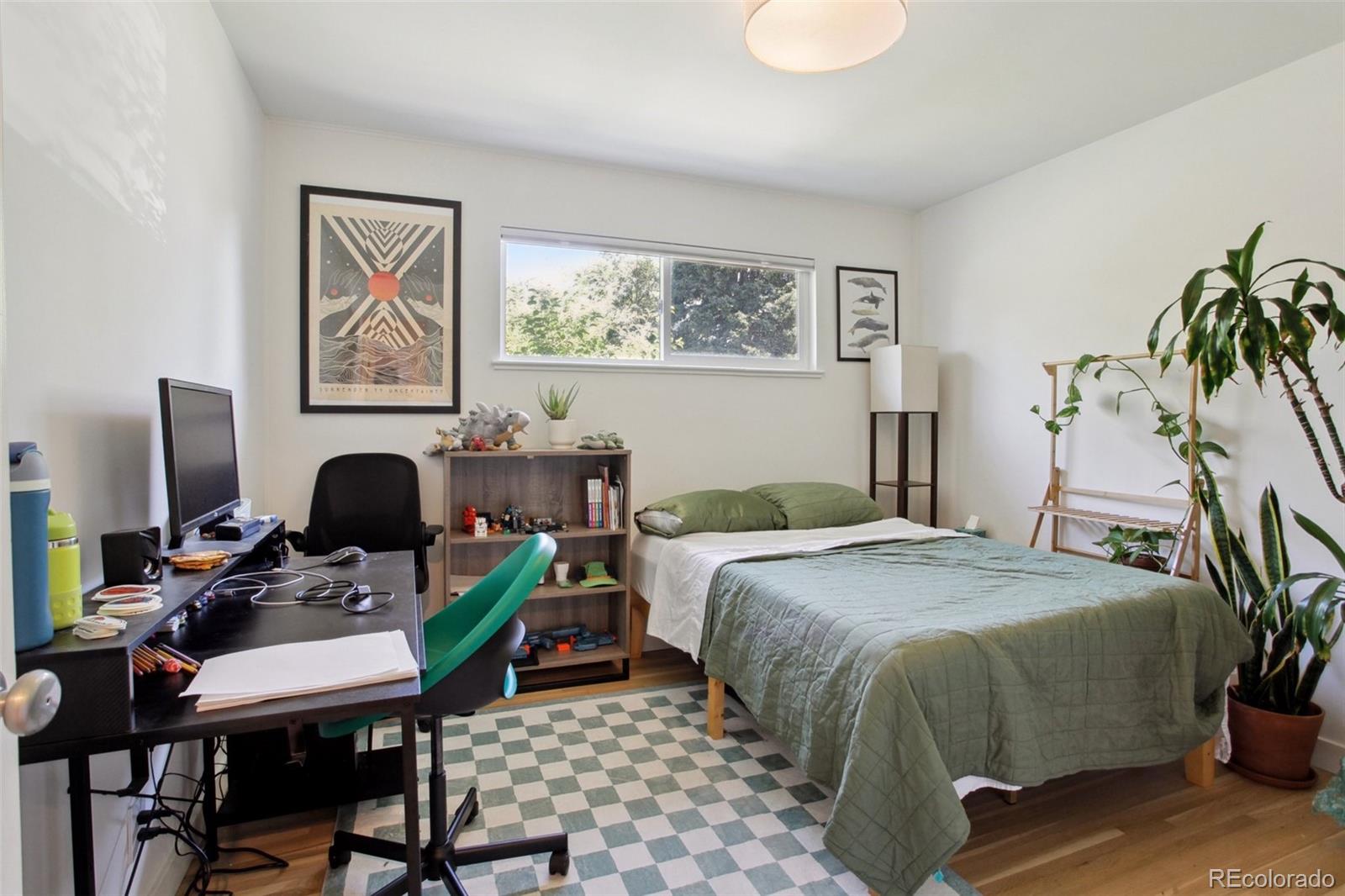 7130 West 30th Avenue Wheat Ridge, CO 80033 - Photo 20 of 37 a bedroom with a bed and a table