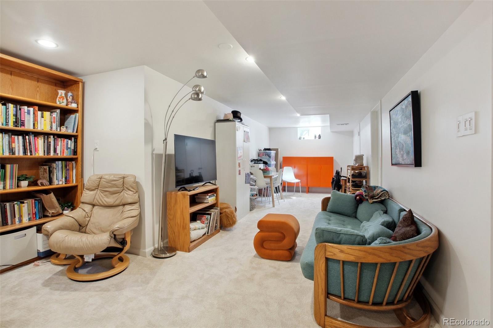 7130 West 30th Avenue Wheat Ridge, CO 80033 - Photo 27 of 37 a living room with furniture and a flat screen tv