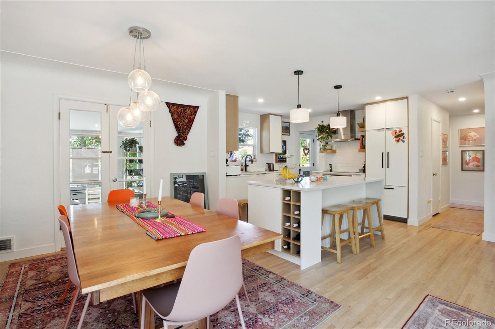 7130 West 30th Avenue Wheat Ridge, CO 80033 - Photo 8 of 37 a view of a dining room with furniture and wooden floor