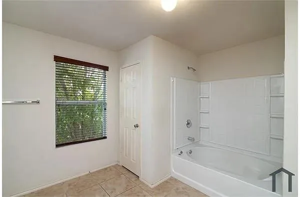 a bathroom with a bathtub and shower