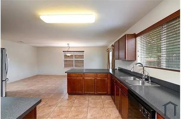 a kitchen with stainless steel appliances a sink stove and cabinets