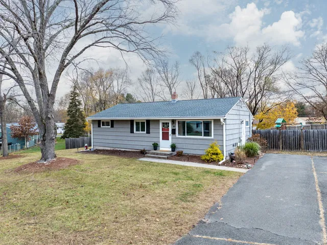 a view of a house with a yard covered in snow