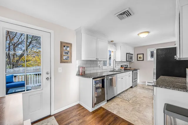 a large kitchen with a stove a sink and a refrigerator