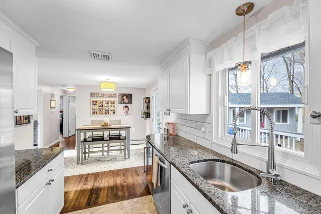 a kitchen with granite countertop a sink and stove