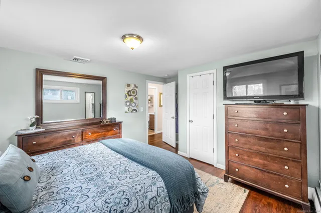 a bedroom with a bed and a dresser in it