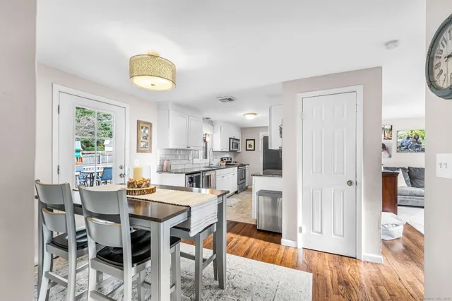 a view of a dining room with furniture and wooden floor
