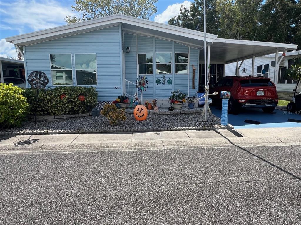 1001 Starkey Road, Unit 758 Largo, FL 33771 - Photo 1 of 37 a front view of a house with garden