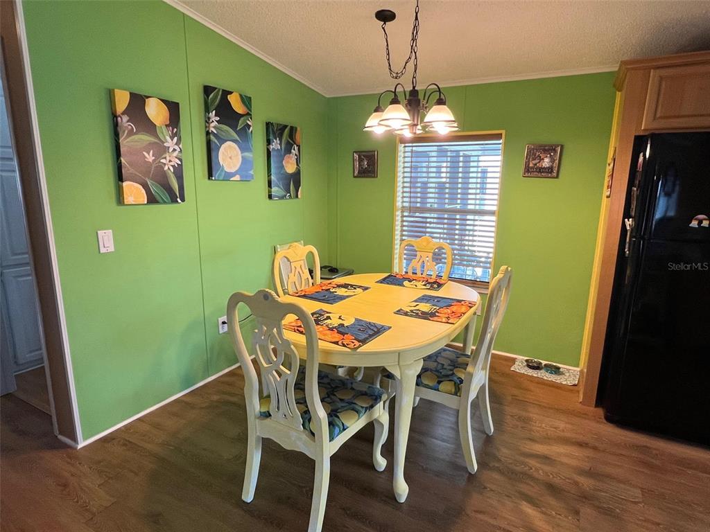 1001 Starkey Road, Unit 758 Largo, FL 33771 - Photo 12 of 37 a view of a dining room with furniture window and wooden floor