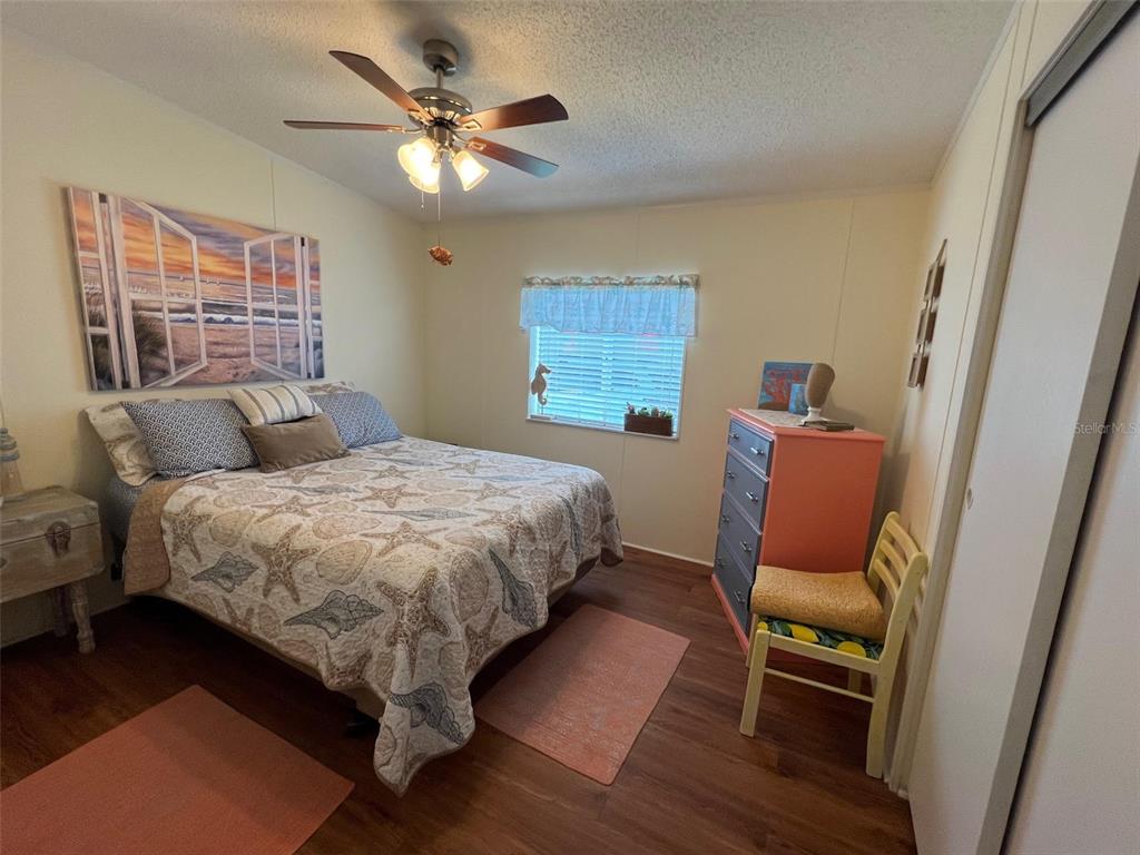 1001 Starkey Road, Unit 758 Largo, FL 33771 - Photo 31 of 37 a bedroom with a bed and furniture