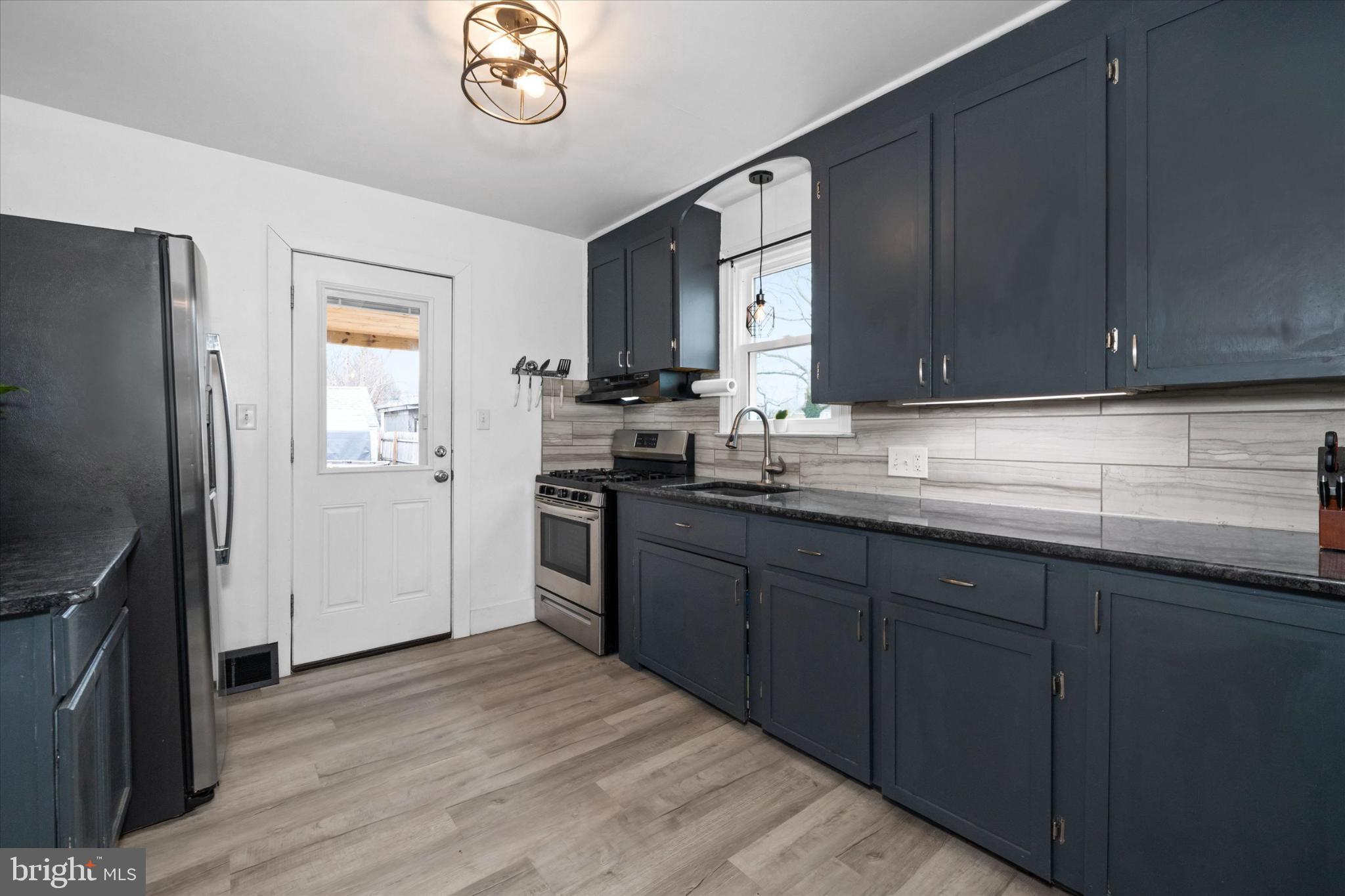 7 2nd Avenue New Castle, DE 19720 - Photo 36 of 44 Modern kitchen with sleek navy cabinetry.