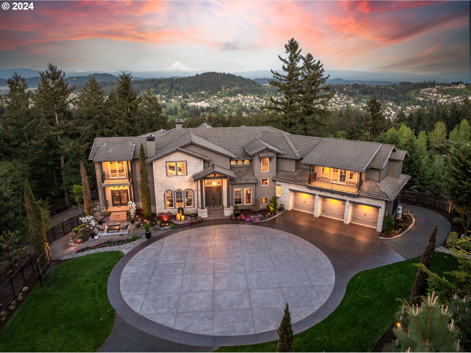 an aerial view of a house with a garden and lake view