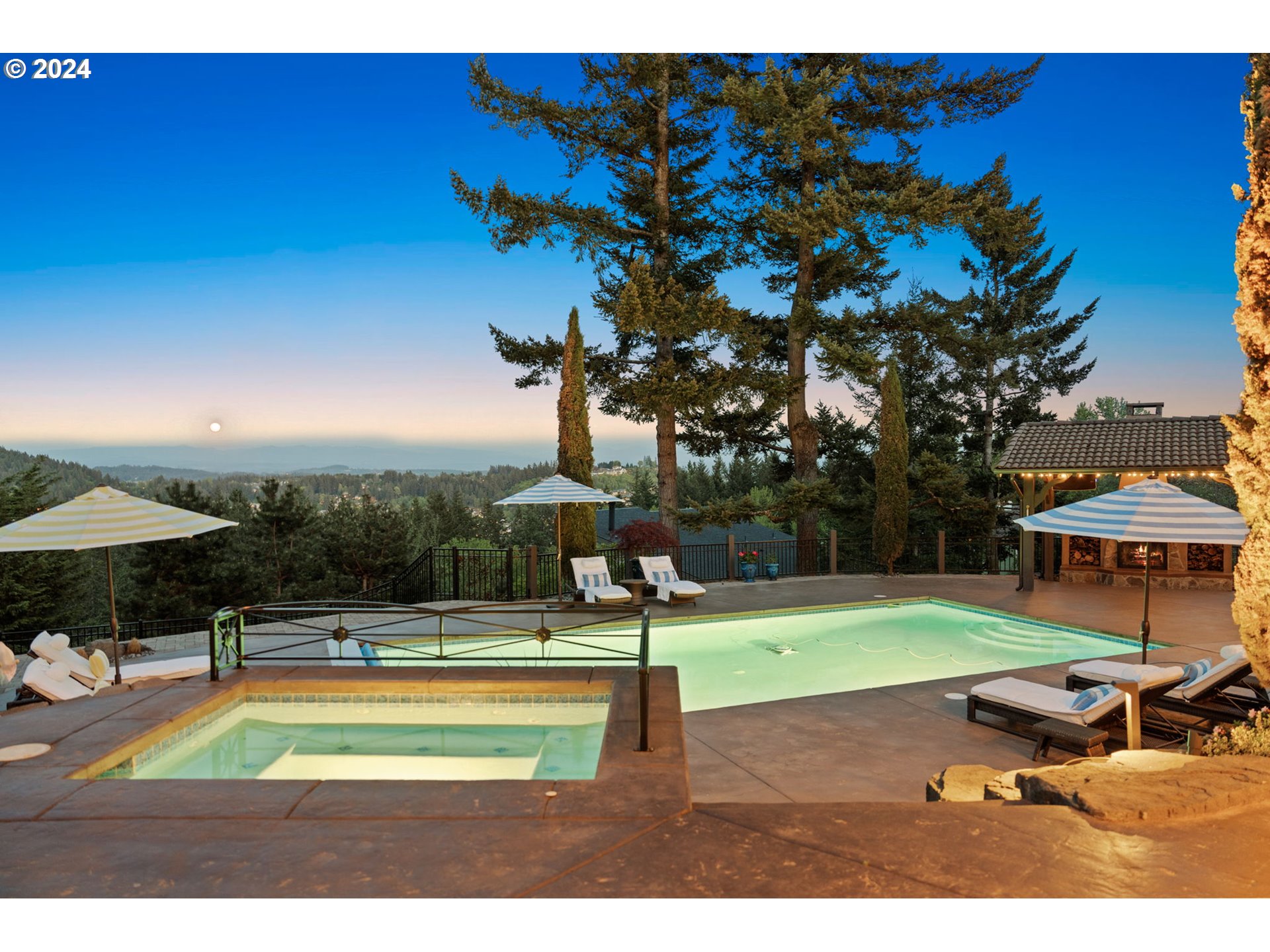11800 Southeast Idleman Road Happy Valley, OR 97086 - Photo 3 of 46 a view of a swimming pool with lawn chairs under an umbrella