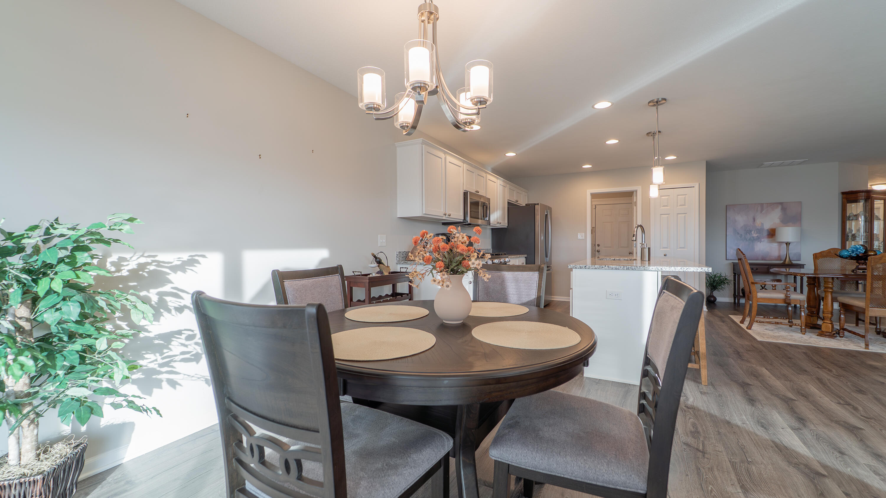 11792 Rhode Island Street Crown Point, IN 46307 - Photo 16 of 30 a view of a dining room with furniture and wooden floor