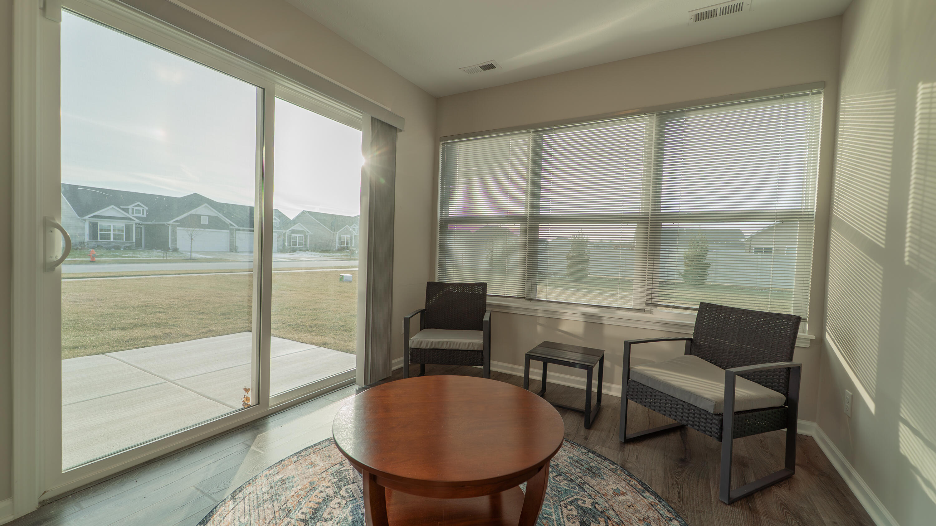 11792 Rhode Island Street Crown Point, IN 46307 - Photo 21 of 30 a living room with furniture and a floor to ceiling window